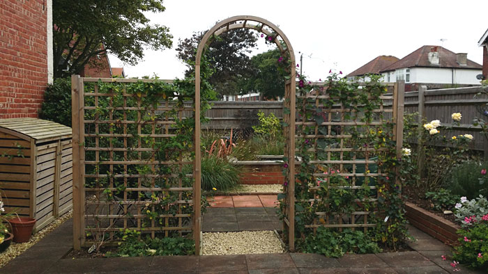 A trellis and arch divides the space