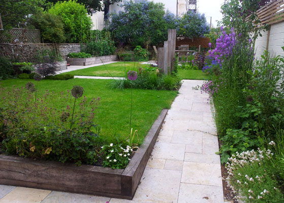 Two lawns, a pond and deep planting borders